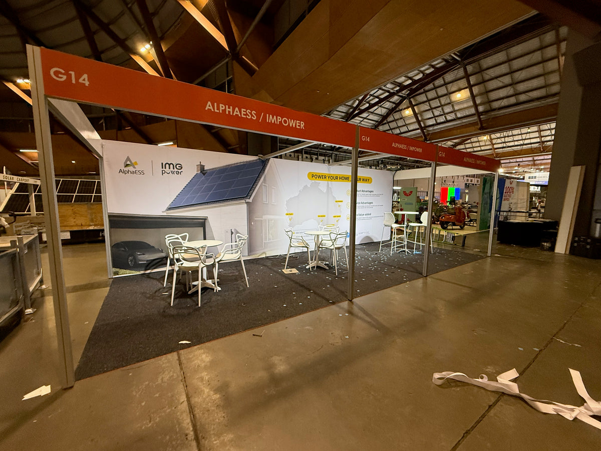 IMPOWER at Everything Electric 2026: turning a shell-scheme wall into a branded backdrop — IMPOWER — Build-stage photograph from the venue.