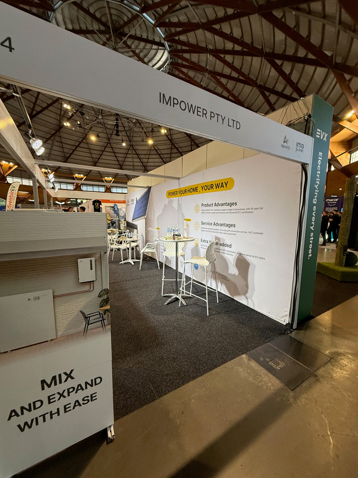 IMPOWER at Everything Electric 2026: turning a shell-scheme wall into a branded backdrop — IMPOWER — Delivered display at Everything Electric 2026.