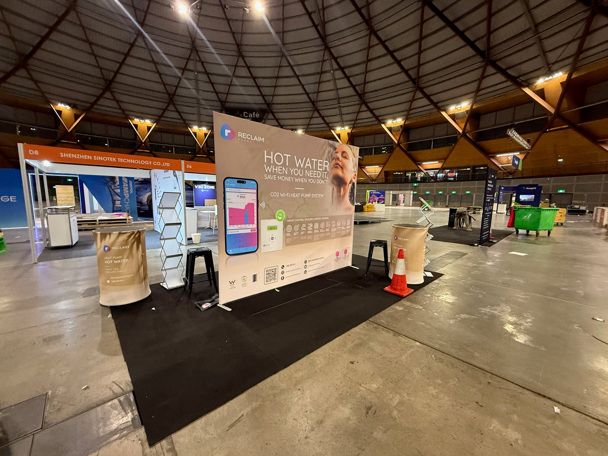 Reclaim Energy at Everything Electric 2026: two product stories on one double-sided display — Reclaim Energy — Build-stage photograph from the venue.