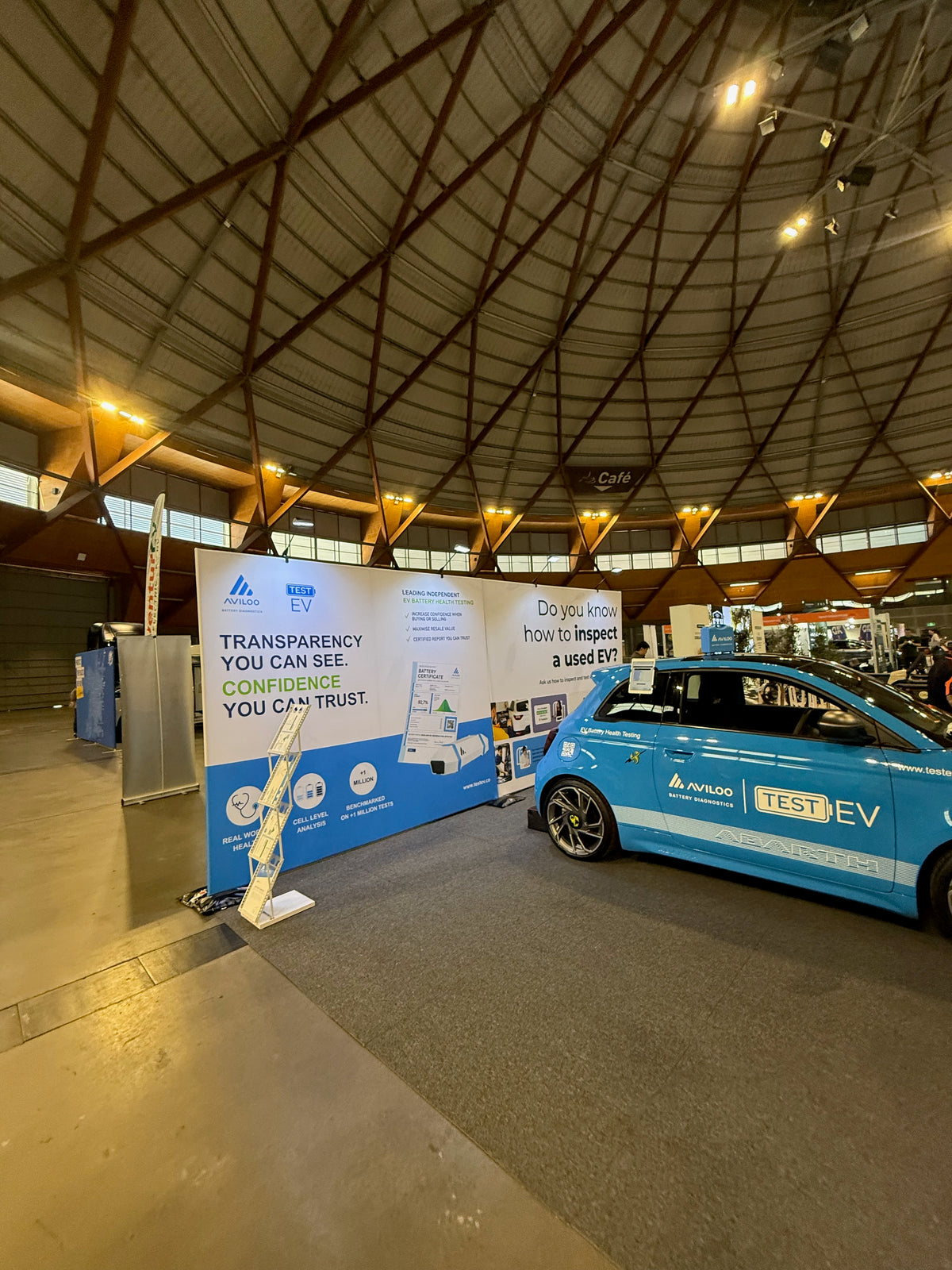 Test EV at Everything Electric 2026: from design to delivery — Delivered Test EV and AVILOO graphic display beside the blue display car at Everything Electric 2026